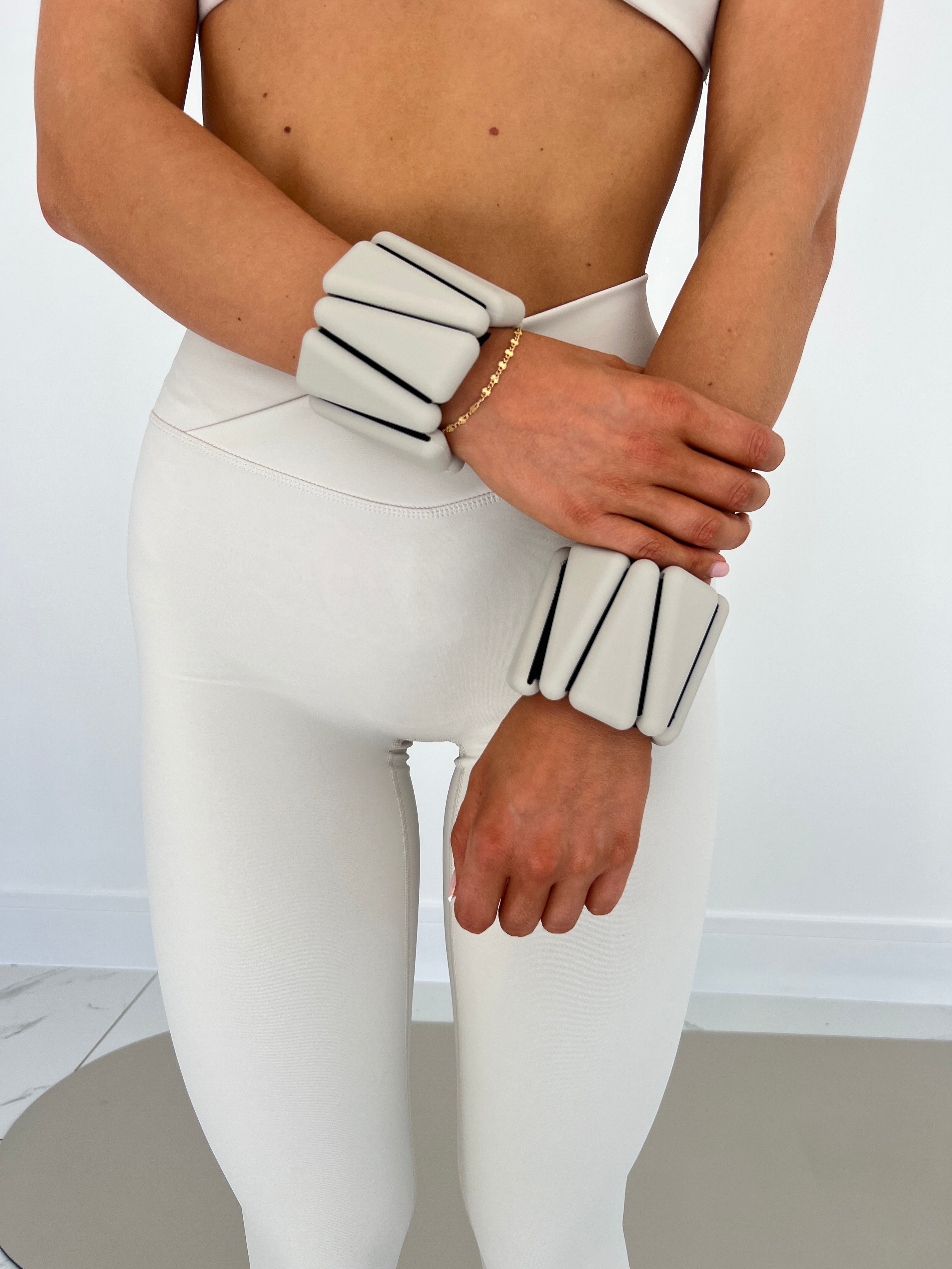 Person wearing a white outfit with black stripes on a plain background